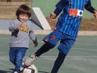 Her grandchildren playing with a soccer ball