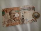 Here you can see a 50 pula bill, 5 pula coin and 5 thebe