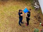 A coworker dumping a bucket of water on me while another one sprays me with foam during "Carnaval".