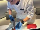 A staff member preparing a dish at the Festive Brunch