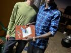 My husband and my host brother Billy pose with a gift we gave him for his 25th birthday. While giving of gifts is common at weddings and baby showers, people typically don't give gifts or money for birthdays.
