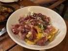 A local dish, huevos rotos, topped with jamón ibérico, or Iberian ham