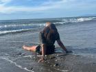 Enjoying the waves and sun at Liquica black sand beach!