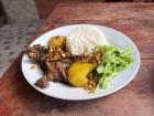 Fried guinea pig with peanuts, rice, and potatoes