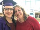 My mom and stand in my former elementary school's library after parading through in my high school cap and gown!