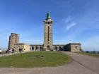 A lighthouse stands at the edge of Cap Fréhel