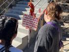 Here I'm reading a sign outside of a temple. It's giving people the rules for being respectful at the temple, such as leaving your shoes outside. 