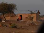 A boma (house) with a solar panel on the roof