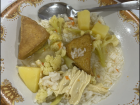 Nasi paket with rice, tofu, potatoes, vegetables and spices