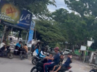 Three kids riding on a motorcycle with their father