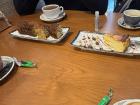 Hot chocolate, slices of orange cake (left), Galician cheesecake (right)