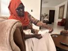 Relative in Lagos showing a cloth her grandmother wove from hand-spun cotton. 