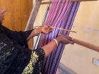 Mrs. Ovavu pulls the Ochi-aya (pink stick) and inserts the Okaha into the first layer.