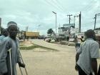 A man on crutches walking through a busy street. There are many people with disabilities here who do not have accessible transportation.
