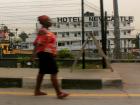 A woman walking along the side of the road.