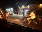 Okada zipping past stores late at night. 