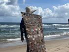 A man selling earrings along the beach