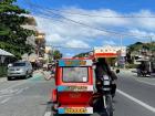 In Kalibo City riding a tricycle, a small car attached to motorcycles