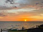 Sunset at the beach nearby small fishing boats