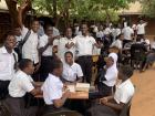 Students working outside as there is not enough space for them in the classroom