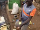 Fortunate's father selling maize on the side of the road (500 MWK/cob) to get enough money to pay the 35,000 MWK ($10) for his son's term 2 tuition