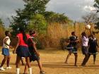 In netball you receive points for getting the ball through the hoop similar to basketball, however there is no dribbling. Instead the ball is passed like in ultimate frisbee: you can't move once you catch the ball!