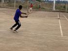 Two students playing singles in a tournament