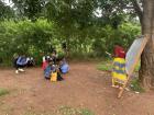 Open school students using the portable chalkboard to study agriculture before starting school at 2pm