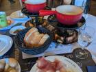 I have enjoyed eating fondue, which is melted cheese, with bread, cured meat and pickles.