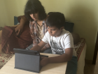 Doing Math homework with his cousin's help