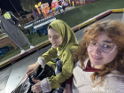 Enjoying the bumper cars at a fair with my friend Hoda, though I was a little scared