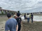 Watching and listening, as the volunteers set up the measurement rope