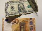 A €50 euro next to a $1 bill--although I rarely use cash in this country, I usually keep have some on me