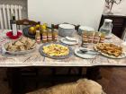 Tasting table with typical Easter cakes, apple juice made by the farm and bread and olive oil