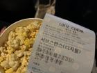 Hye-yun eating popcorn at the cinema