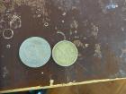 An Ecuadorian 50 cent piece and a U.S. dollar coin