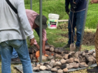 placing the rocks and food in the hole