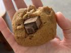 A chocolate chip cookie with one big chocolate chunk