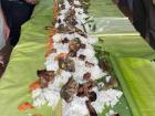 A boodle fight includes lots of rice, grilled meat and some veggies