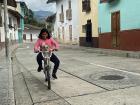 Valentina and her dog, Chispa, on the bike.