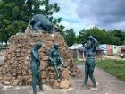 An Hombre Caiman statue by the river in Plato 