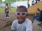 A kid donning a pair of pipe cleaner glasses!