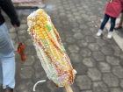 An Elote Loco, or crazy corn, a popular street and festival food. It's sweet corn with mayo, ketchup, spicy green salsa, and crumbly cheese