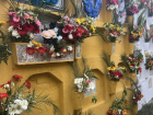 Relatives leave flowers and wreaths on the graves of their family members