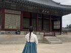 This is me wearing a traditional style Korean dress called hanbok. I was in front of a Korean traditional building.