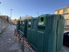 Large trash sorting bins situated just outside the city center