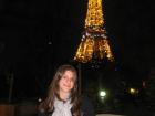 A photo of me in front of the Eiffel Tower, which lights up at night and sparkles once an hour