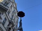 The renowned "Man Hanging Out" statue, depicting a man holding an umbrella in Prague.