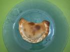 An empanada is a dough pocket filled with meat and vegetables