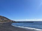 The sand in the northern part of Tenerife is black because the island was formed by a volcano
